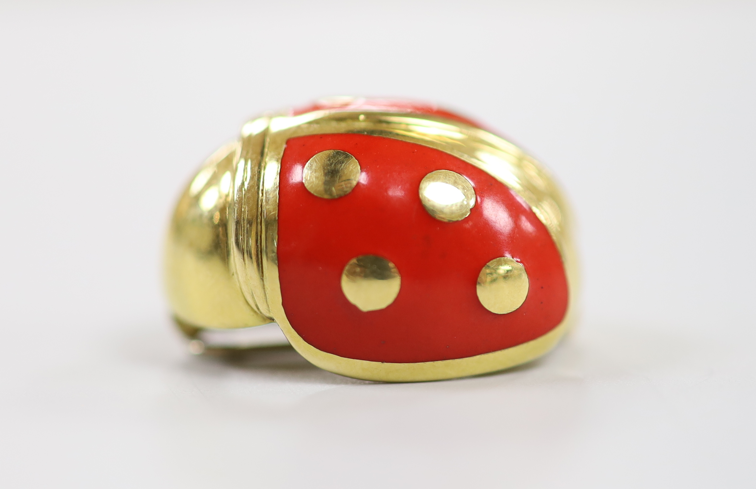 An 18ct gold, enamel and diamond chip set novelty clip brooch, in the form of a ladybird, by Mappin & Webb?, 20mm, gross weight 7.5 grams.